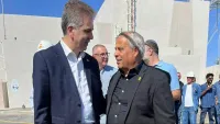 שדה סולארי רחב באזור מדברי ליד דימונה עם פאנלים סולאריים וברקע העיר והנגב